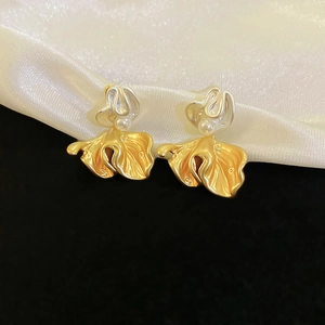 Vintage bicolour flower petal earrings with pearl inlay on white satin background
