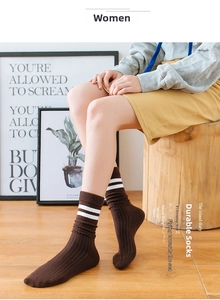 Detail of brown ribbed cotton crew socks with white stripes in a cozy lifestyle setting