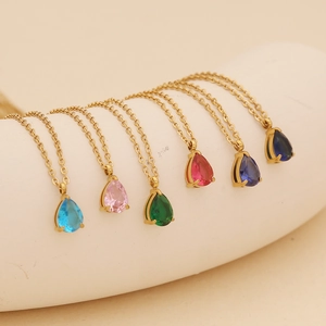 Set of six gold chain necklaces with colorful pear-cut gemstone pendants displayed together