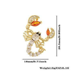 Detail view of a gold scorpion pendant with dimensions 20.5mm x 18mm and cubic zirconia
