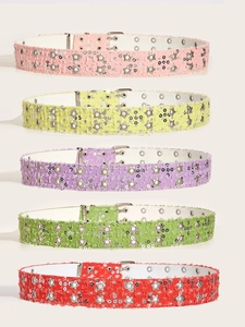 Close-up of vibrant star studded punk belts in pink yellow purple green and red denim fabrics