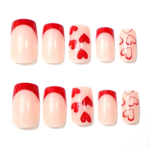 Detailed view of red French heart press-on nails in medium square shape set