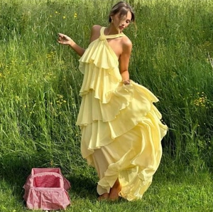 Sleeveless yellow tiered chiffon maxi dress with floral halter neck for summer vacation
