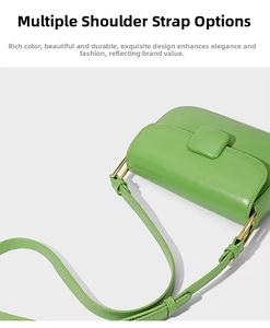 Detail view of the green crossbody bag side showing the strap attachment and gold hardware