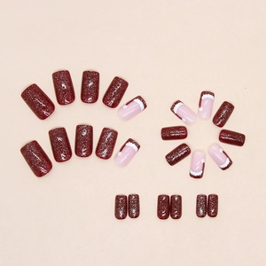 Deep red glitter Christmas press-on nails with cute Santa hat designs in medium length
