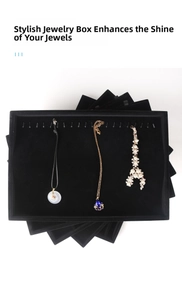 Detail of black velvet jewelry tray with metal hooks for displaying necklaces