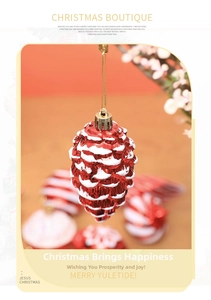 Detail of red pine cone Christmas ornament with snow effect and golden hanging loop