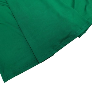 Detail shot of the precise double-needle stitching on the hem of this green dress