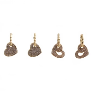 Detailed view of four golden heart earrings with crystals in solid and hollow styles