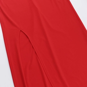 Détail de la fente latérale et du tissu rouge texturé sur la robe de soirée chic
