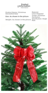 Close-up of red glitter Christmas tree topper bow hanging on a green pine branch
