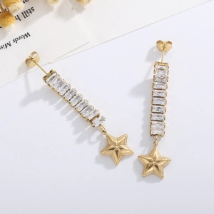 Detail view of long tassel earrings with sparkling zircons and gold star pendants