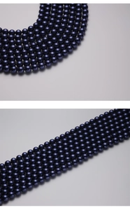 Detailed view of navy blue round faux pearls with smooth glossy finish for DIY jewelry