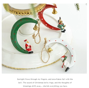 Detailed view of moon-shaped Christmas ornaments with Santa, reindeer, and golden bells