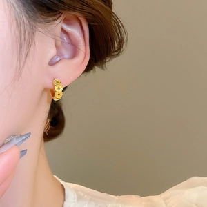 Close-up of 18k gold plated copper coin drop earrings worn by a model in vintage style