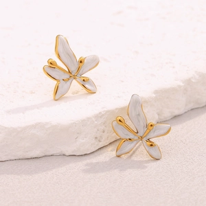 Detailed macro shot of 18K gold plated floral stud earrings with white enamel finish