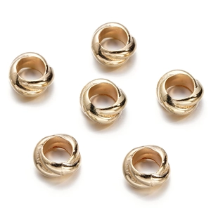 Detail of golden CCB metal spacer beads with rope texture for DIY jewelry making