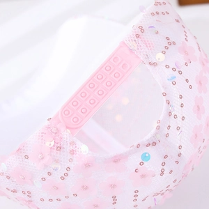 Detailed view of the pink lace baseball cap featuring mesh fabric and plastic snap closure