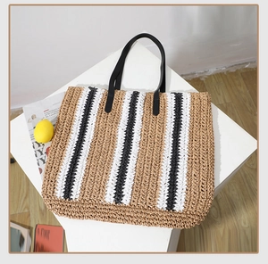 Macro shot of striped straw tote bag texture and durable black PU leather shoulder straps