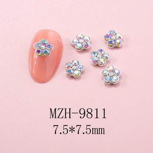 Detailed 7.5x7.5mm flower nail charm with silver base and AB rhinestones on pink nails
