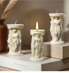 Three ivory Roman column candles with Athena relief carvings in varying heights