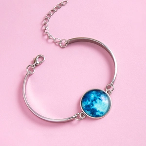 Adjustable silver bangle with a luminous blue moon glass gem and starry sky effect