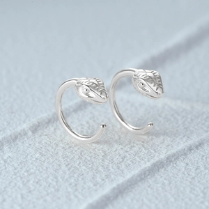 Macro view of minimalist S925 sterling silver snake head stud earrings with fine details
