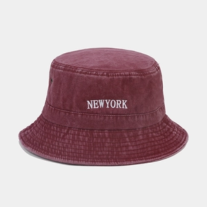 Macro detail of wine red washed cotton bucket hat with white New York embroidery