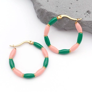 Close-up of bamboo-style earrings with pink and green enamel on golden stainless steel