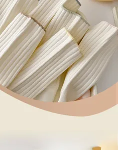 Close-up of ribbed cotton crew socks featuring contrast colored trim in cream white