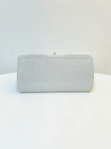 Detailed view of silver glitter evening clutch bag with rectangular metal clasp lock