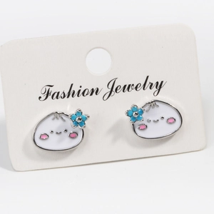 Detail of cute white enamel bun earrings with pink blush and blue flower on display card
