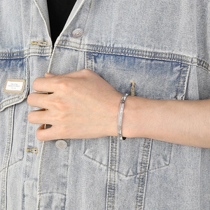 Minimalist silver C-shaped titanium steel cuff bracelet with engraved pattern on wrist