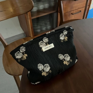 Jacquard fabric makeup bag with black vintage rose pattern and zipper closure