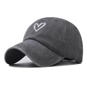 Close-up of vintage washed charcoal grey baseball cap with white heart embroidery