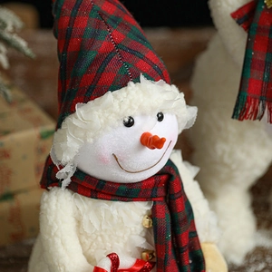 Plush Christmas snowman decoration with red and green plaid hat and carrot nose ornament