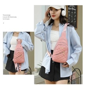 Detail of pink quilted nylon crossbody chest bag with adjustable strap and zip pockets