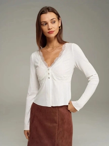 Elegant white ribbed knit long sleeve top with V-neck lace trim and metal buttons
