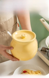 Macro detail of high-capacity yellow ceramic seasoning jar with lid and spoon for kitchen