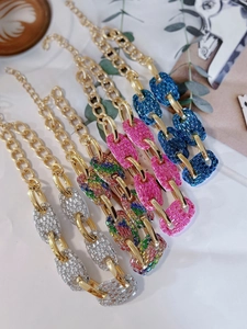 Detailed view of glamorous pavé pig nose link necklaces in multiple colors for party gifts.