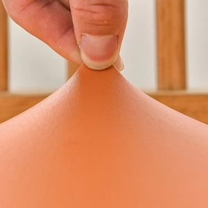 Waterproof orange PU leather chair seat cover showing elastic stretch and durable texture