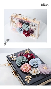 Close-up of luxury acrylic evening clutch featuring 3D floral petals and gold hardware