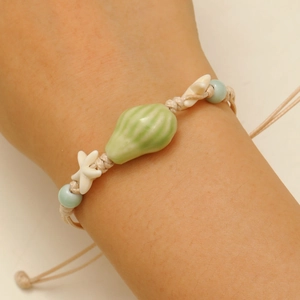 Adjustable ocean themed handmade rope bracelet with ceramic conch and starfish charms