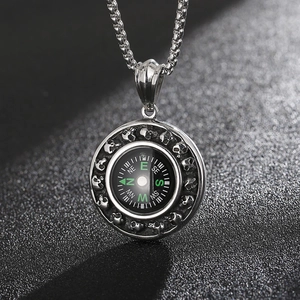 Macro shot of stainless steel skull compass pendant with punk rock vintage finish details
