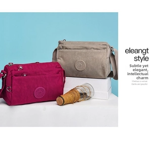 Detail of multi-pocket nylon shoulder bags in khaki and rose red on a blue backdrop