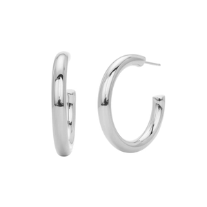 Macro detail of polished silver C-shape stud earrings with smooth metallic finish