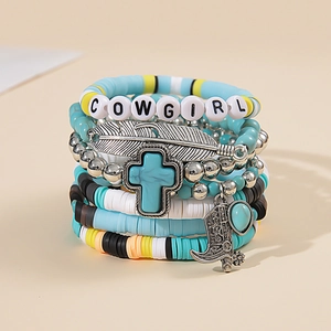 Detail of bohemian layered bracelets with turquoise, feather charms and Cowgirl beads