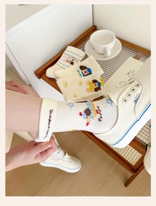 Detail of embroidered little puppy pattern on premium cotton blend mid-calf socks