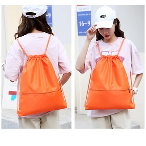 Front and back view of a bright orange drawstring backpack with a convenient zipper pocket