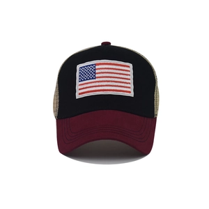 Detailed close-up of embroidered USA flag patch on a classic trucker baseball cap